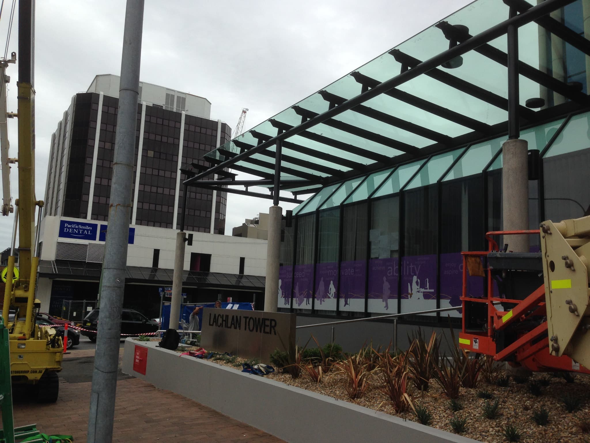 Steel-framed glass canopy outside a commercial building